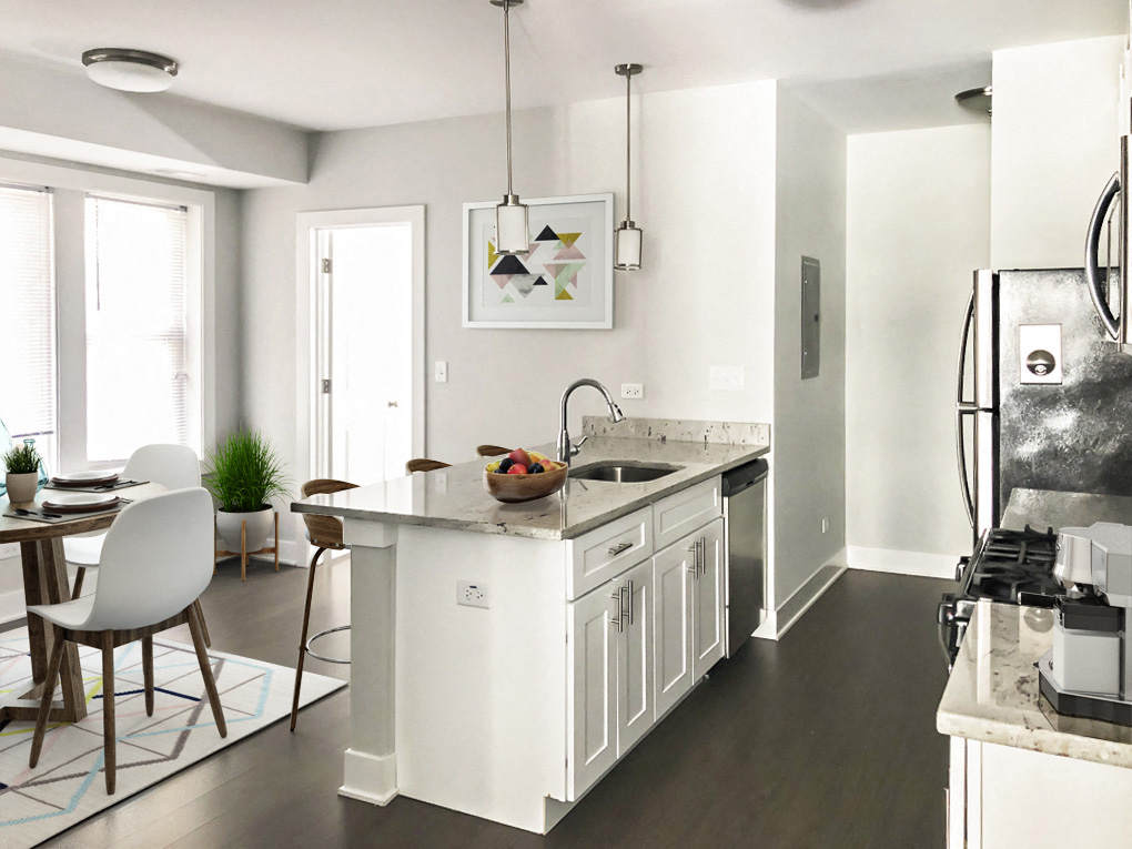 a white kitchen with a large island and a dining room